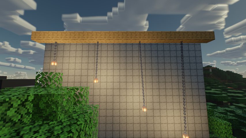 Lanterns hanging on chains against a stone wall, each casting colored light